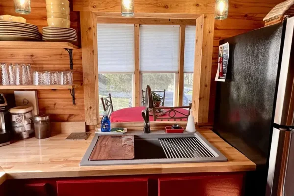 Red Roof Retreats - Red Roof Log Cabin, interior - full kitchen with window leading to dining area - Lake of Egypt - Goreville, IL