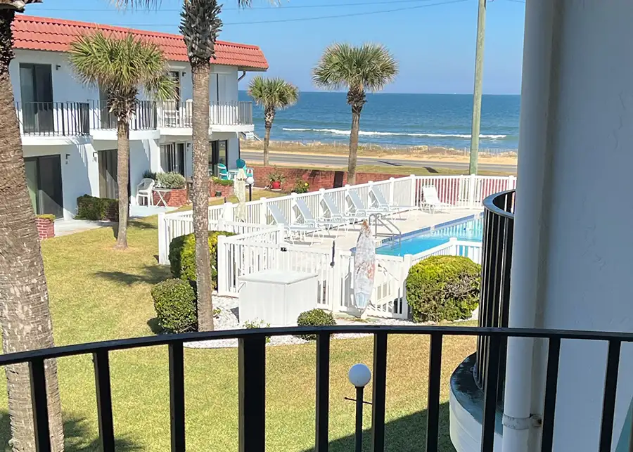 Red Roof Retreats - FLORIDA property - Shellabrate Beach Pad - view from 2nd floor balcony, beach and swimming pool are visible - Flagler Beach, FL